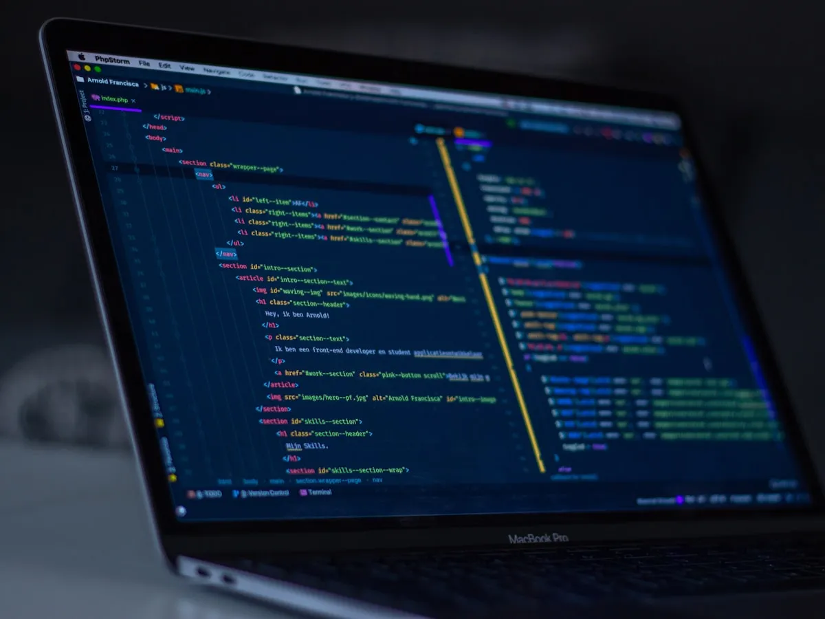 A developer working at a desk with code on screen, building and inspecting PDF form fields